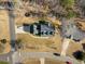 Bird's eye view shows the house, driveway with cars, and well-manicured landscaping on a sunny day at 3222 Windmere Dr, Sanford, NC 27330