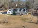 Aerial view of a home with a large yard and mature trees on a sunny day at 3222 Windmere Dr, Sanford, NC 27330