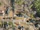 An aerial view of a neighborhood showcasing mature trees and well-spaced homes with ample yards at 3222 Windmere Dr, Sanford, NC 27330