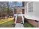 Home exterior with an enclosed back porch and a stairwell from the porch down to the yard at 3222 Windmere Dr, Sanford, NC 27330