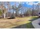 The spacious backyard with a trampoline, and a well-manicured lawn at 3222 Windmere Dr, Sanford, NC 27330