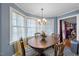 Charming dining area with bright windows and a classic wooden table at 3222 Windmere Dr, Sanford, NC 27330