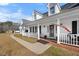 Inviting front porch with white railings and space for seating, leading to the front door at 3222 Windmere Dr, Sanford, NC 27330