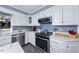 Bright kitchen with white cabinets, stainless steel appliances, and stylish countertop at 3222 Windmere Dr, Sanford, NC 27330