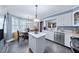 Bright kitchen with white cabinets, stainless steel appliances, and a breakfast nook at 3222 Windmere Dr, Sanford, NC 27330
