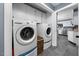 Convenient laundry area with modern washer and dryer, built-in cabinets, and access to the kitchen at 3222 Windmere Dr, Sanford, NC 27330