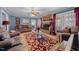 Comfortable living room with a brick fireplace, French doors, and hardwood floors at 3222 Windmere Dr, Sanford, NC 27330