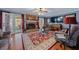 Cozy living room with a brick fireplace, hardwood floors, and plenty of natural light at 3222 Windmere Dr, Sanford, NC 27330