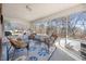 The sunroom features wicker chairs, a ceiling fan, and a large area rug at 3222 Windmere Dr, Sanford, NC 27330