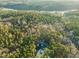 Secluded property featuring a modern home, pool, circle driveway, and surrounded by mature trees at 336 Timberline Dr, Pittsboro, NC 27312