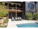 This backyard features a dark exterior home, swimming pool and lounge area at 336 Timberline Dr, Pittsboro, NC 27312