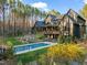 Sprawling backyard featuring home exterior, inground pool, and mature trees at 336 Timberline Dr, Pittsboro, NC 27312