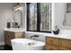 This bathroom features a soaking tub and a black-framed window with wooded views at 336 Timberline Dr, Pittsboro, NC 27312