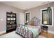 Bedroom with an iron frame bed, a bookshelf, neutral walls, and natural light at 336 Timberline Dr, Pittsboro, NC 27312