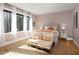 Cozy bedroom featuring a wood-framed bed, neutral walls, bright windows and two armchairs at 336 Timberline Dr, Pittsboro, NC 27312