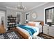 This bedroom features built-in shelves, a modern chandelier, and is connected to a full bathroom at 336 Timberline Dr, Pittsboro, NC 27312
