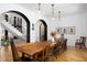 Dining room featuring a long wooden table, chandelier lighting, and views to the staircase at 336 Timberline Dr, Pittsboro, NC 27312