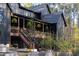 Charming home exterior with a cozy covered deck and lush garden beds, creating a welcoming outdoor space at 336 Timberline Dr, Pittsboro, NC 27312