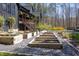 Back exterior with raised garden beds and access to deck with stairs and distant view of pool at 336 Timberline Dr, Pittsboro, NC 27312