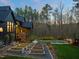 Beautiful home exterior with landscaped gardens, a pool, and a charming back porch, perfect for outdoor living at 336 Timberline Dr, Pittsboro, NC 27312