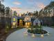 Stunning modern home features a circular driveway, black window frames, and beautiful landscaping at 336 Timberline Dr, Pittsboro, NC 27312