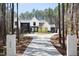 Impressive two-story home with a concrete driveway, landscaped grounds, and a private wooded lot at 336 Timberline Dr, Pittsboro, NC 27312