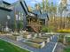 Striking black modern home with raised garden beds, stairs to deck, and a glimpse of the backyard pool at 336 Timberline Dr, Pittsboro, NC 27312