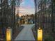Scenic view of a modern home with a long driveway winding through a lush, wooded landscape at dusk at 336 Timberline Dr, Pittsboro, NC 27312