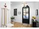 Bright foyer with hardwood floors, stylish lighting, and a black front door, creating a welcoming entrance at 336 Timberline Dr, Pittsboro, NC 27312