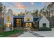 Stunning two-story home featuring a modern black and white exterior with a well-manicured lawn and inviting entryway at 336 Timberline Dr, Pittsboro, NC 27312