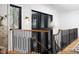 Hallway featuring natural wood floors, black trimmed windows, a modern chandelier, and natural lighting at 336 Timberline Dr, Pittsboro, NC 27312