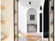 Bright interior hallway with open archways, shelving, and a cowhide rug on hardwood floors at 336 Timberline Dr, Pittsboro, NC 27312