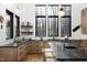 Bright, stylish kitchen featuring black countertops, natural wood cabinets, and modern appliances at 336 Timberline Dr, Pittsboro, NC 27312