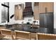 Updated kitchen showcasing natural wood cabinets, black countertops, and stainless-steel appliances at 336 Timberline Dr, Pittsboro, NC 27312