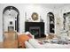Bright living room featuring hardwood floors, black fireplace, and white couch at 336 Timberline Dr, Pittsboro, NC 27312