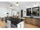 Spacious kitchen with a black island with seating connecting to a dining and living area at 336 Timberline Dr, Pittsboro, NC 27312