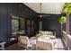 Relaxing covered outdoor patio with comfortable seating and ceiling fan for warm weather at 336 Timberline Dr, Pittsboro, NC 27312