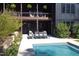 A serene pool area with outdoor seating, patio and a two-story house, perfect for relaxation and entertainment at 336 Timberline Dr, Pittsboro, NC 27312