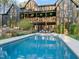 Expansive backyard with pool, patio, and well-maintained landscaping for relaxing and entertaining at 336 Timberline Dr, Pittsboro, NC 27312