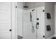 Modern walk-in shower featuring unique tile work, glass enclosure, and black hardware at 336 Timberline Dr, Pittsboro, NC 27312