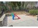 Spacious backyard with a stone patio area and a colorful playset at 3929 Glenlake Garden Dr, Raleigh, NC 27612