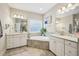 Expansive bathroom with dual vanities, a soaking tub, and ample counter space offering comfort and luxury at 3929 Glenlake Garden Dr, Raleigh, NC 27612