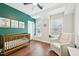 Bright Bedroom with hardwood floors, stylish decor, and a cozy rocking chair next to a window at 3929 Glenlake Garden Dr, Raleigh, NC 27612