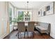 The dining room features a table with chairs and a bench beneath a window with hanging light fixture at 3929 Glenlake Garden Dr, Raleigh, NC 27612