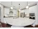 A kitchen with a marble island, stainless steel appliances, pendant lights and plenty of cabinet storage at 3929 Glenlake Garden Dr, Raleigh, NC 27612