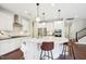 Bright, spacious kitchen with white cabinets, a central island, and stylish pendant lighting at 3929 Glenlake Garden Dr, Raleigh, NC 27612