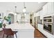 Bright, open kitchen with a large island, stainless steel appliances, and modern pendant lighting at 3929 Glenlake Garden Dr, Raleigh, NC 27612