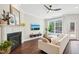 Bright living room with a cozy fireplace, hardwood floors, and a large window at 3929 Glenlake Garden Dr, Raleigh, NC 27612