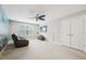 Spacious living room with a leather recliner, ceiling fan, and a mounted television for a relaxing ambiance at 3929 Glenlake Garden Dr, Raleigh, NC 27612
