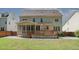 A large backyard features both a wooden deck and a screened in porch and a stone patio at 400 Leacroft Way, Morrisville, NC 27560